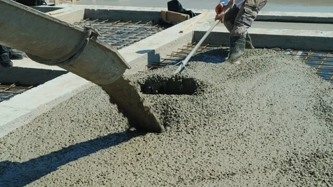 Making the floor in a private cottage. From the machine mixer pours concrete on Stock Footage 90539559