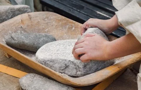 Making flour in a traditional way for the Neolithic era Stock Photos