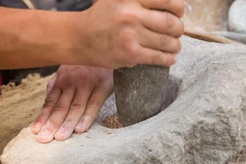 Making flour in a traditional way for the Neolithic era Stock Photos