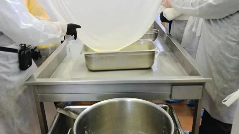 Making fresh cheese in a kitchen with hands-on practice and simple methods for e Stock Footage 325729016