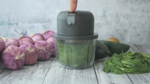 Making fresh herb mix with a chopper and vegetables Stock Footage 324690605