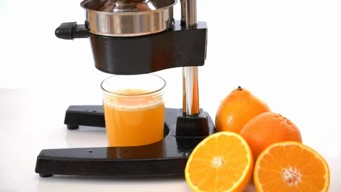 Making fresh juice out of oranges Stock Footage 93884285