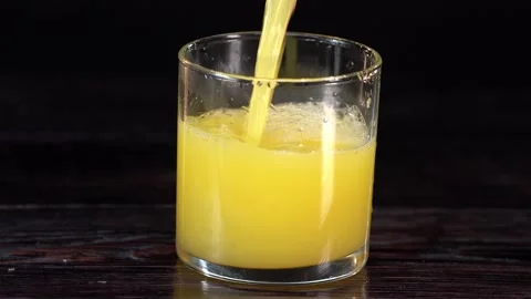Making Fresh Juice. Slow motion detailed shot of pouring delicious apple juice Stock Footage 154413017