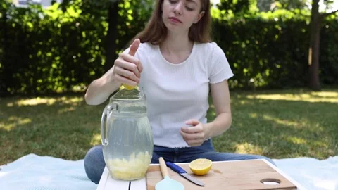 Making fresh lemonade in a sunny backyard with homemade ingredients Stock Footage 297369898