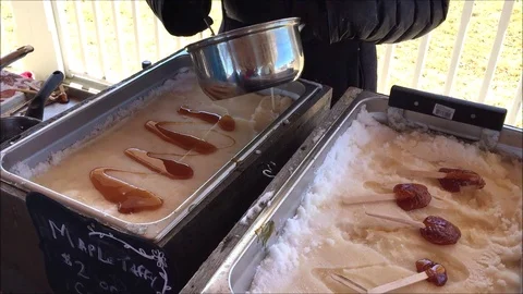 Making fresh maple syrup taffy lollipops Stock Footage 104124390