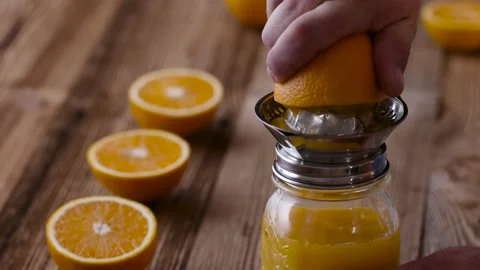 Making Fresh Orange Juice With A Handheld Orange Juicer. Stock Footage 143566711