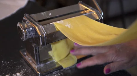 Making fresh pasta with a traditional style pasta machine. 4K UHD. Video stock 51807700