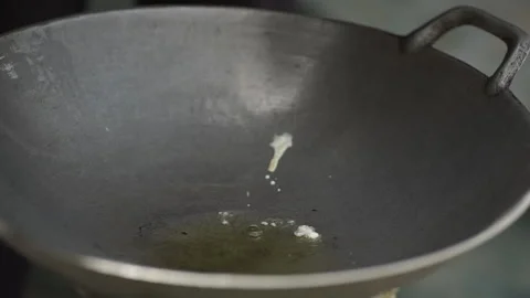 Making fried eggs in a hot frying pan Stock Footage 134115415