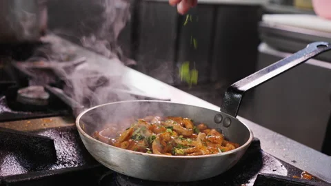 Making fried pork meal - sprinkle with green parsley leaves Video stock 152610695