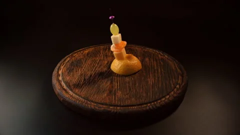Making fruit canapes with cheese, pear, grapes and tangerine Video stock 148637821