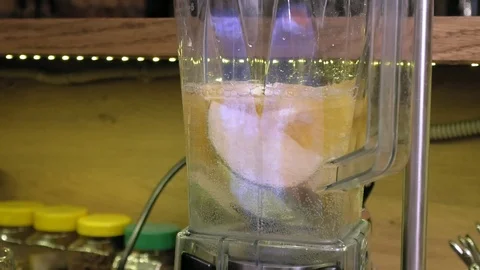 Making a fruit cocktail in a blender Stock Footage 105985547