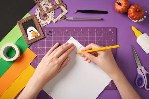Making a ghost portrait craft. Hands draw the silhouette of a ghost on pape.. Stock Photos