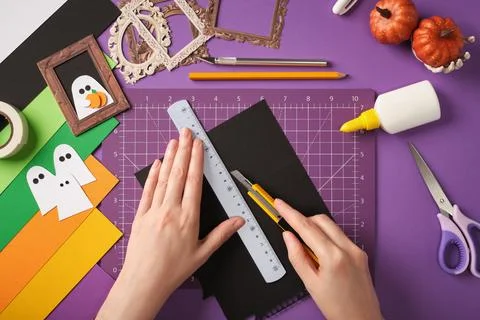 Making a ghost portrait craft. Hands cut out the background for the picture f Stock Photos