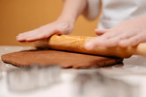 Making ginger dough by rolling out a wooden rolling pin. Stock Photos
