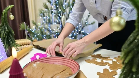 Making gingerbread horses for Christmas by the decorated tree Stock Footage 344820353