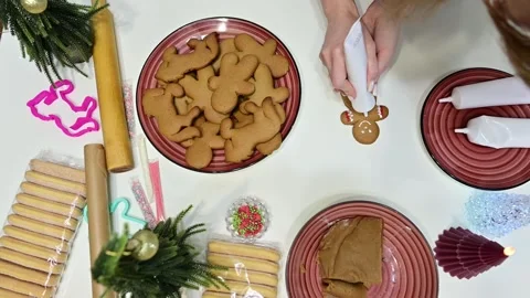 Making gingerbread men and decorating with buttons in Christmas spirit Stock Footage 344819654