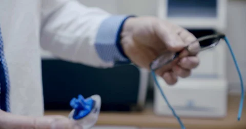 Making glasses, Close up. The ophthalmologist inserts the finished lens into the Stock Footage 130105429