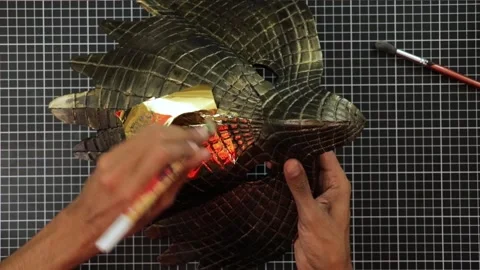 Making a golden eagle mask 001 Stock Footage 242960105