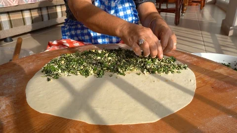 Making gozleme, organic spinach bread with a mother in kitchen. Stock Footage 122438687