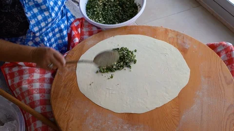 Making gozleme, organic spinach bread with a mother in kitchen. Stock Footage 122440486