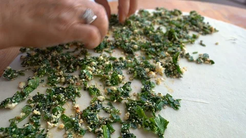 Making gozleme, organic spinach bread with a mother in kitchen. Stock Footage 122440530
