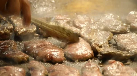 Making of grilled beef  steak on hot plate with smoke Stock Footage 61554452