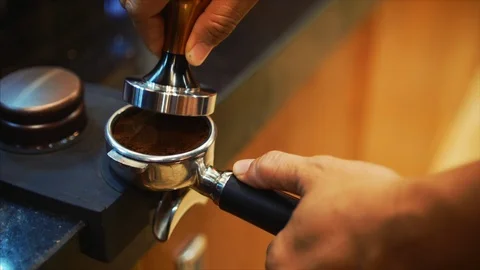 Making Ground Coffee with Tamping fresh coffee. Close-Up. Making coffee from Stock Footage 89550571
