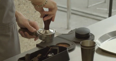 Making Ground Coffee with Tamping fresh coffee. Close-Up. Making coffee from Stock Footage 237828264