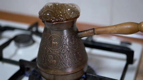 Making Ground Turkish Coffee in a Copper Turk on a Gas Stove. Slow motion Stock Footage 151162567