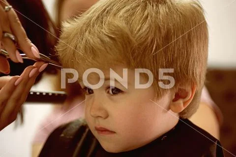 Making haircut fun. Little child given haircut. Small child in hairdressing Stock Photos