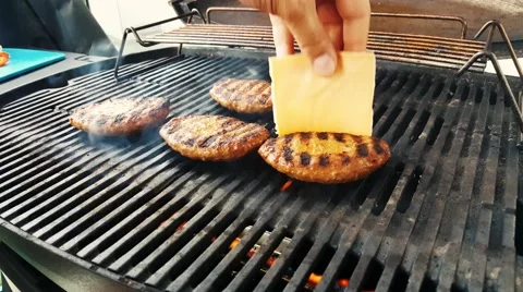 Making Hamburger on grill - Adding cheese Stock Footage 53088984
