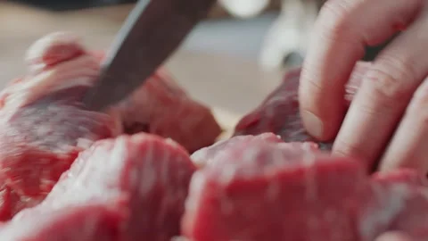 Making Hamburger Meat by Cutting Raw Beef into Small Cubes on a Wooden Board Stockbeeldmateriaal 331101063