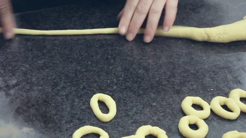 Making by hand donuts whit dough of flour. Typical dessert. Stock Footage 98018080