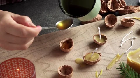 Making of handmade Christmas candles from walnut shells and beeswax Stock Footage 330130846