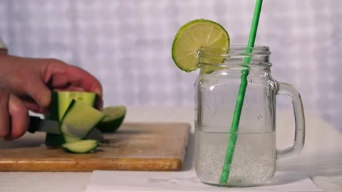 Making healthy cucumber and lime refreshing detox drink Stock Footage 313481960