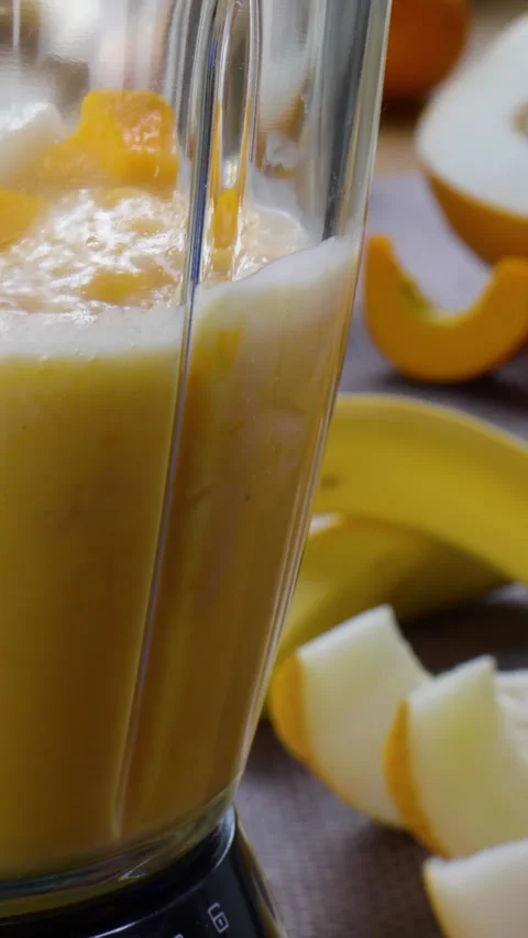 Making a Healthy Raw Vegan Melon banana Smoothie Stock Footage 258595853