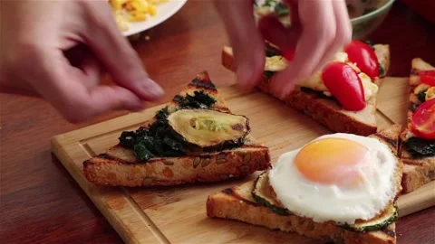 Making healthy sandwich with grilled bread zicchini spinach scramble egg Stock Footage 109037662