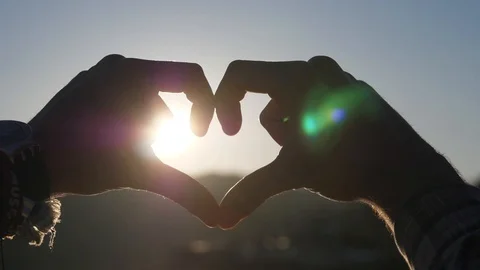 Making heart shape with hands at sunset Stock Footage 85770022