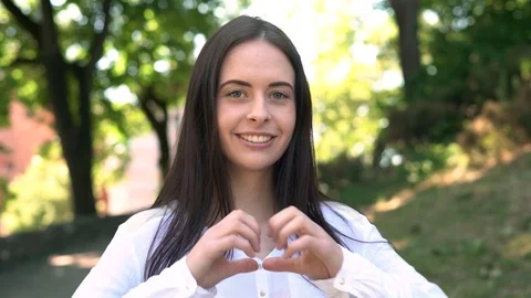 Making heart shape with hands young pretty girl close up portrait Video stock 91245566
