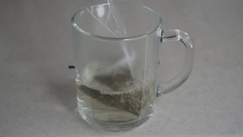 Making herbal tea with teabag in transparent mug Stock Footage 104495081