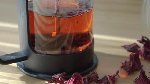 Making hibiscus tea with dried flowers in a glass pot Stock Footage 335565525