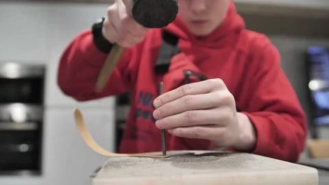 Making a hole with an awl in leather. Stock Footage 172145644