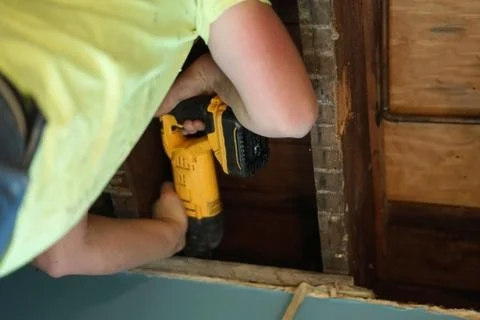 Making a hole in ceiling. Stock Photos