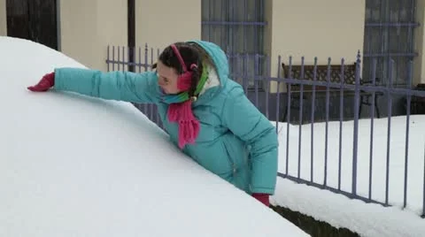 Making hole in snowy car windshield Stock Footage 21251006