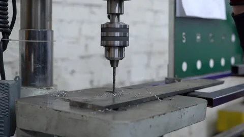 Making holes on a machine with a drill, machine work, drilling holes Stock Footage 157280338