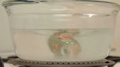 Making holiday easter eggs in transparent pan Stock-Footage 7740762