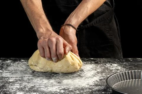 Making homemade bread. Step-by-step instruction. The cook shapes the dough Фото