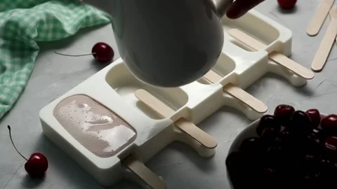 Making homemade cherry popsicles. Stock Footage 197547906