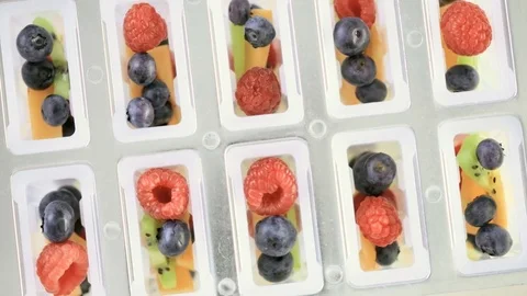 Making homemade fresh fruit popsicles with apple juice. Stock Footage