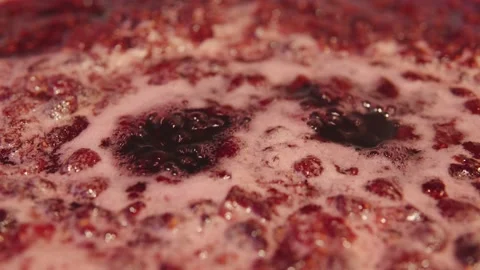 Making homemade raspberry jam. Boiling sweet syrup on the stove closeup. Stock Footage 210548341